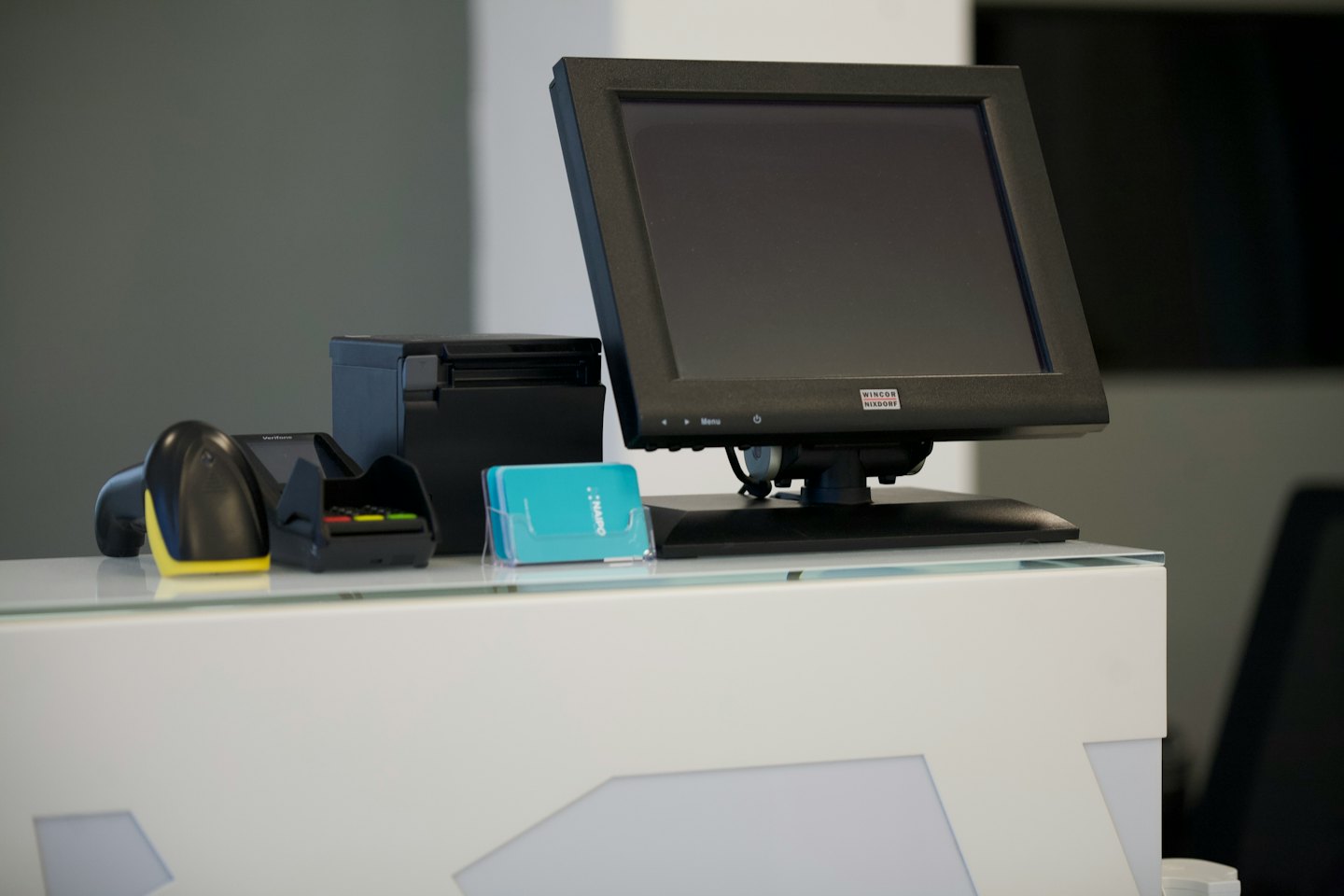 Modern point-of-sale system with payment terminal and scanner.