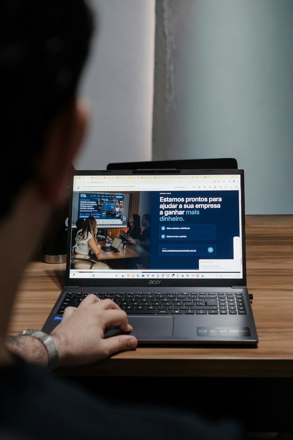 Person uses a laptop displaying business growth information on a desk.